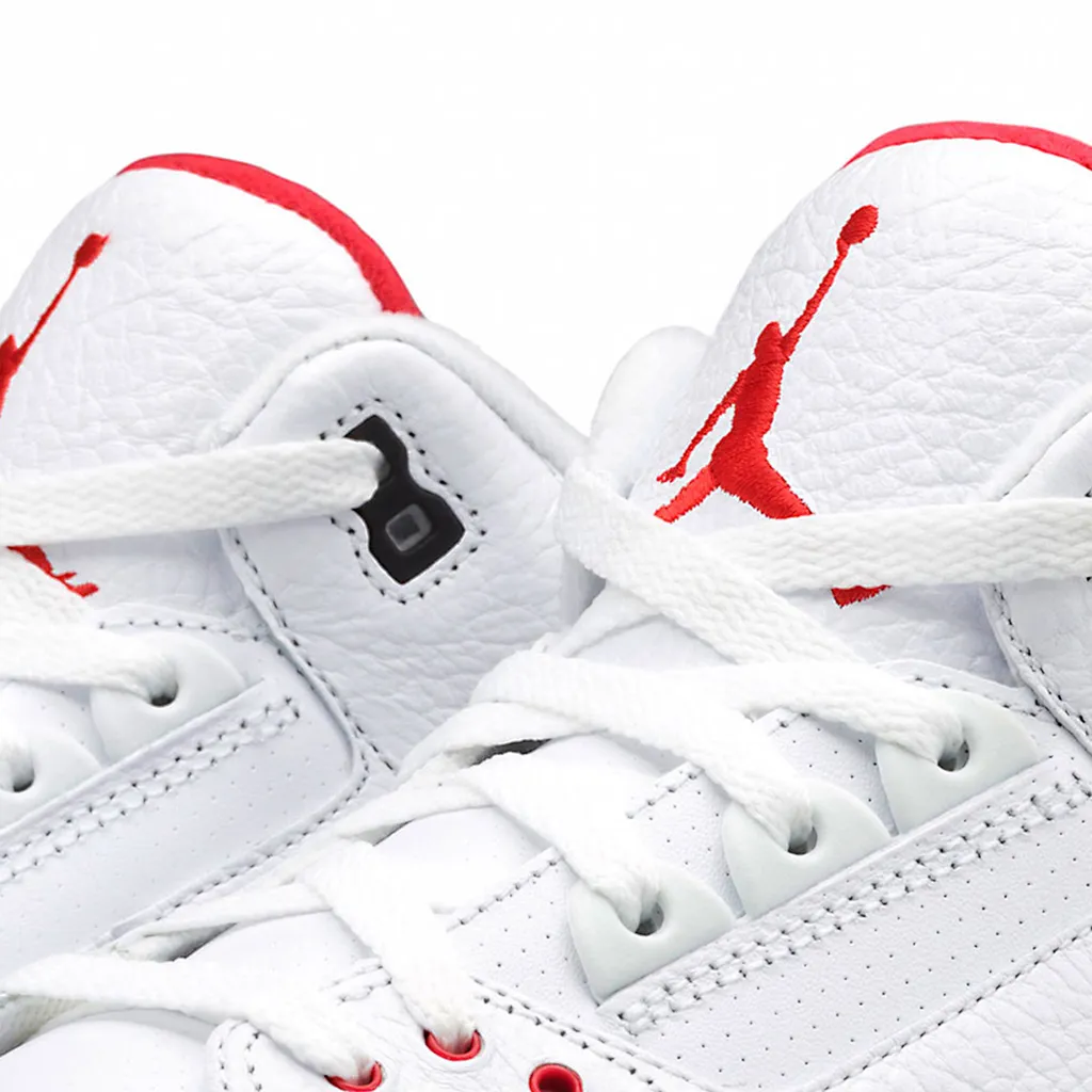 A detail shot of the upper portion of a pair of white Nike's.